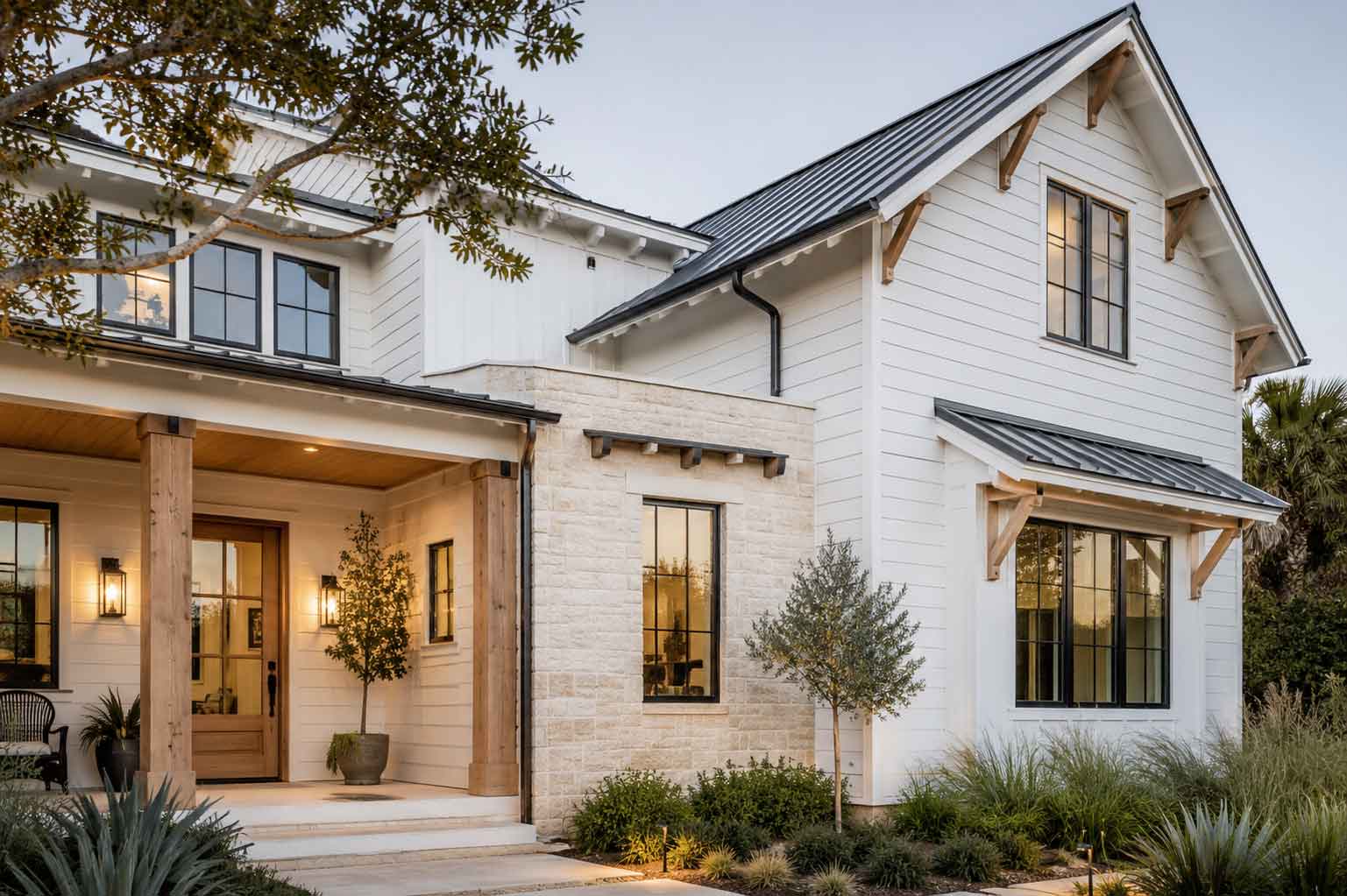 Modern coastal home exterior with white siding and black windows